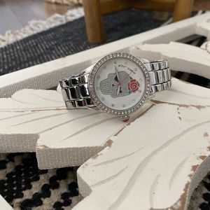Betsy Johnson silver watch with skull and pink rose details.